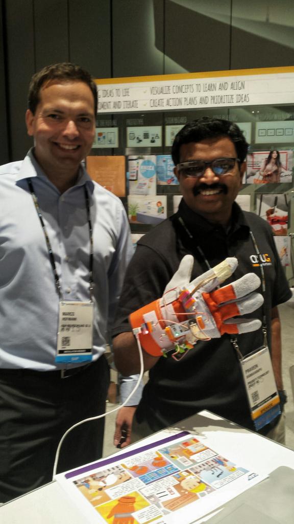 _MichelleNg_'s tweet photo. #sap Marco &amp; #ProSoftTech Praveen get creative w/ safety glove @DTwithSAP @littleBits  #SAPPHIRENOW #meaningfultech http://t.co/v20ASHsbKE