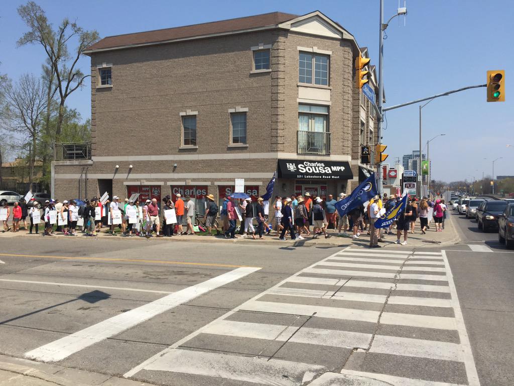 OSSTFD19's tweet photo. There's a large crowd of people protesting outside the office of Ontario's Finance Minister in Mississauga South. http://t.co/8DeSXy4m8Y