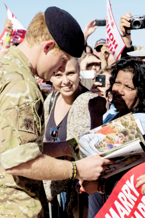 Prince Harry spoke to a woman who was among the first to arrive at the Opera House carrying a book about his mother.
