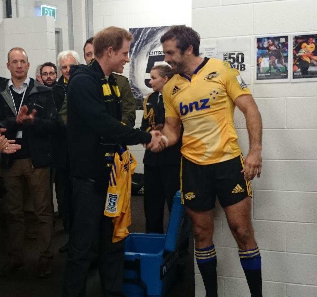.<a href="/Hurricanesrugby/">Hurricanes Rugby</a> captain Conrad Smith presents Prince Harry with a rugby shirt and a babygro for Princess Charlotte