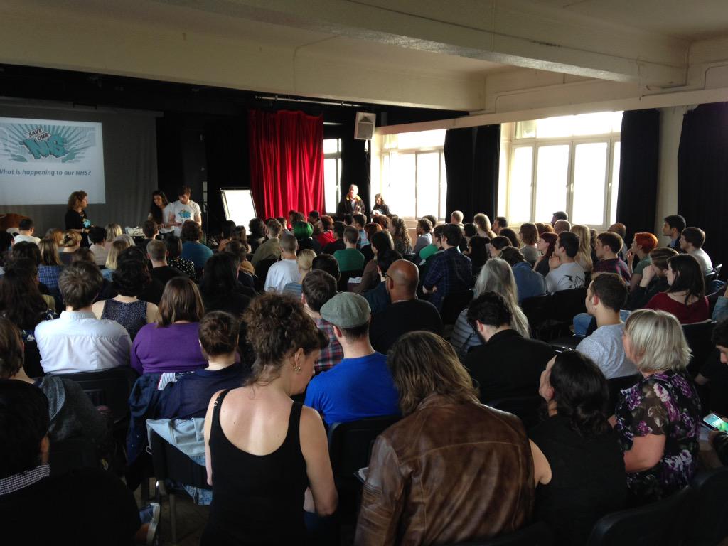 joelalexsmith's tweet photo. Packed room for @SaveOurNHSMCR emergency meeting #ToriesOutNow #NHS @conormcgurran on the mic http://t.co/896HmU9h8l