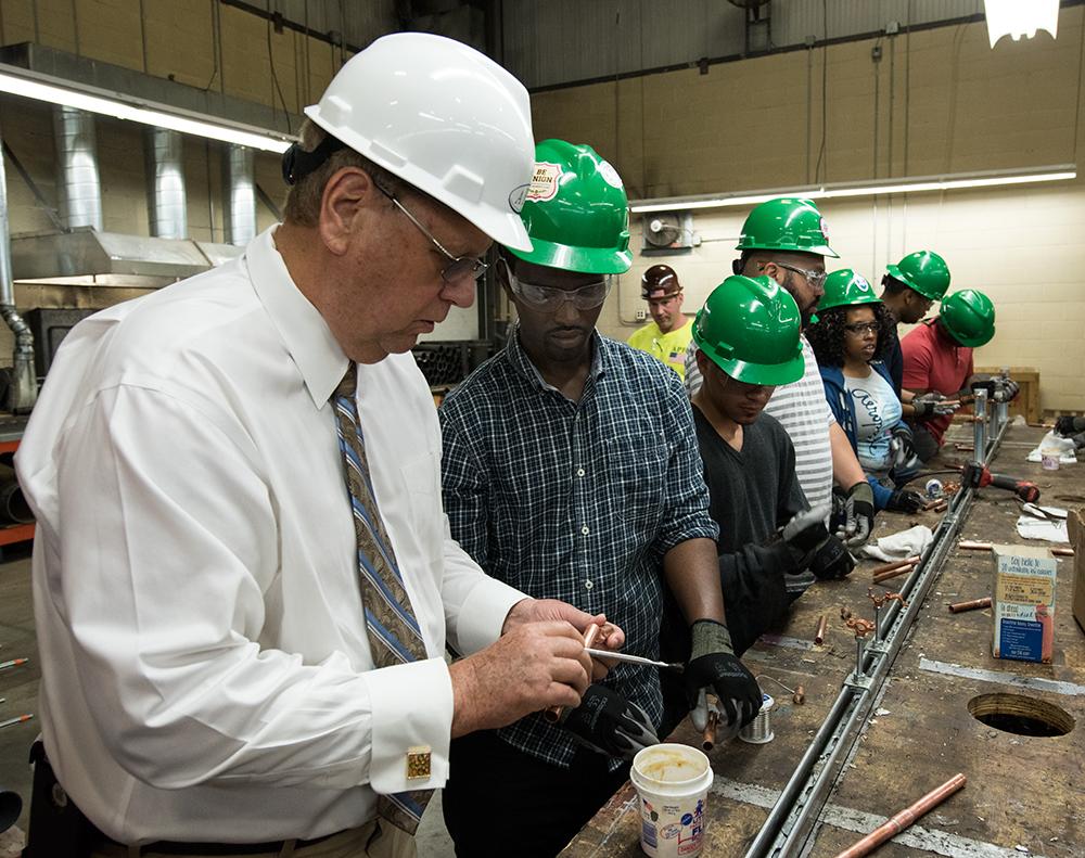 amer_plumb's tweet photo. APH President and Owner, Joe Clancy demonstrates soldering techniques to students from @BldgPathways. http://t.co/jzBtBukDi0