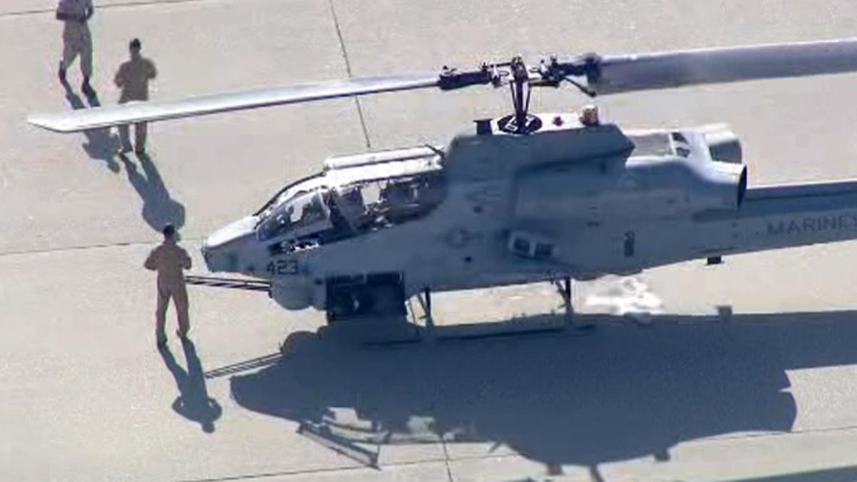 NBCLA's tweet photo. Apache Cobra Marine helicopter forced to make emergency landing in bed of LA River http://t.co/oK6aFBNJEr http://t.co/X7LBsTxvX6