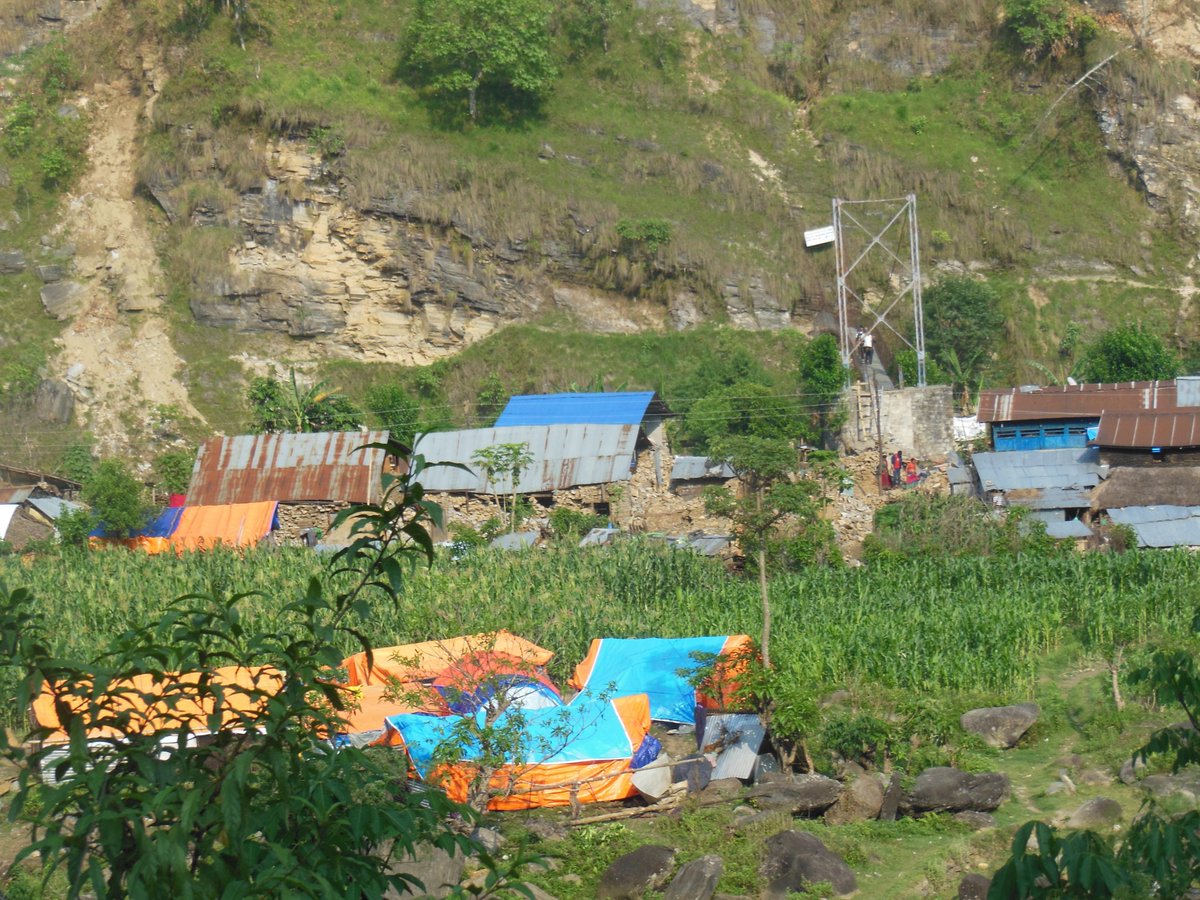 nepalken's tweet photo. damaged houses, colourful tarps, rural suspension bridges are common sight now http://t.co/pfAACZI3Yv