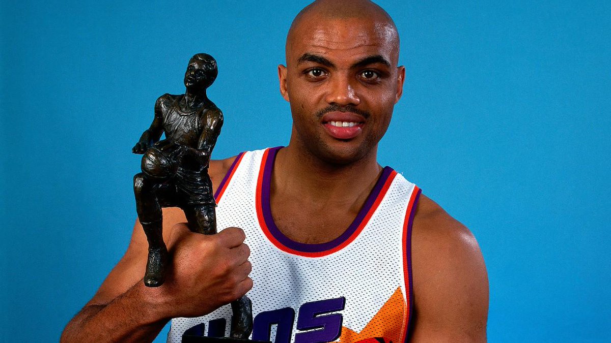 Charles Barkley holding up MVP trophy.