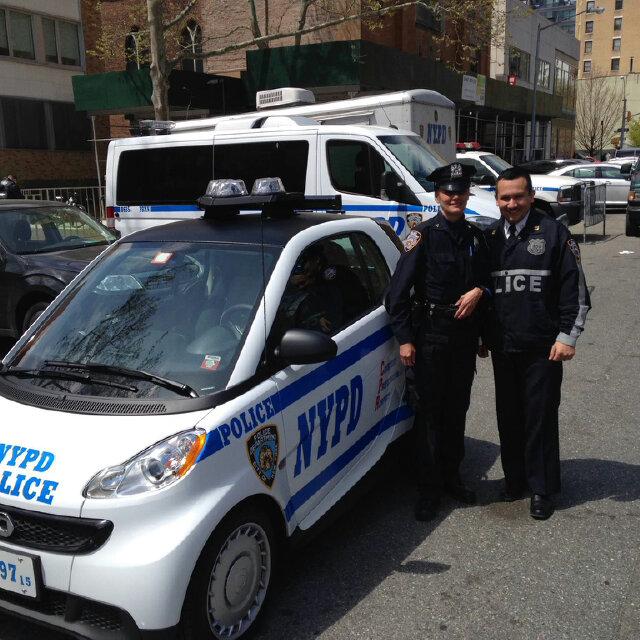 NYPD24Pct's tweet photo. Officer Casanova admires the Smart Car assigned to the @NYPD34Pct. #24Pct #MiniPatrol may be coming soon to the #UWS http://t.co/X7ndH0axk6