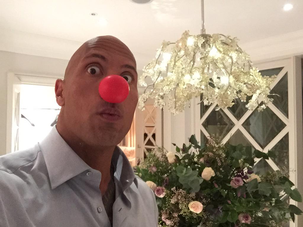 TheRock's tweet photo. Be honest, is there something on my face? Happy #RedNose Day! http://t.co/y2EWPxocBe