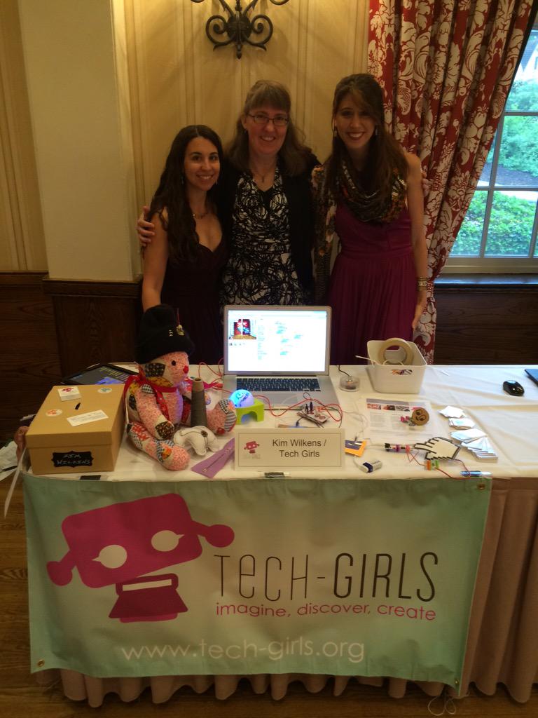 Kim Wilkens (middle) at Tech-Girls table with volunteers.