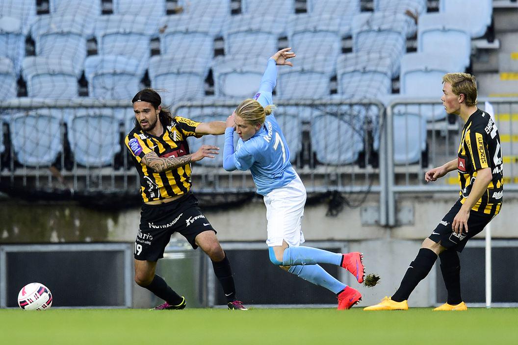 Zuta (far L) battles for the ball with an opponent