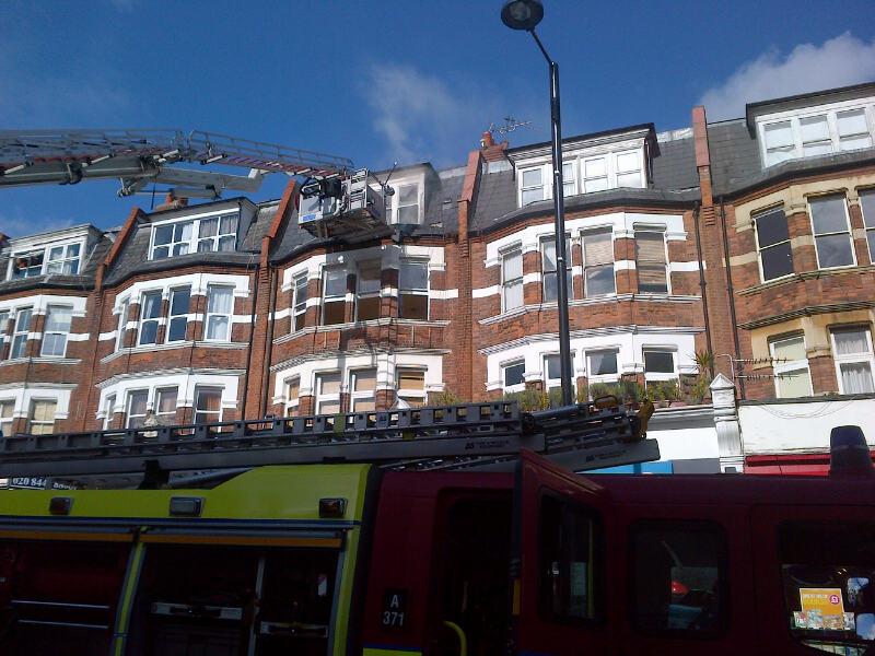 LondonFire's tweet photo. Crews using an aerial ladder platform at the scene of the #NorthFinchley fire which is affecting a 3rd floor flat. http://t.co/lsLo5ADmbo