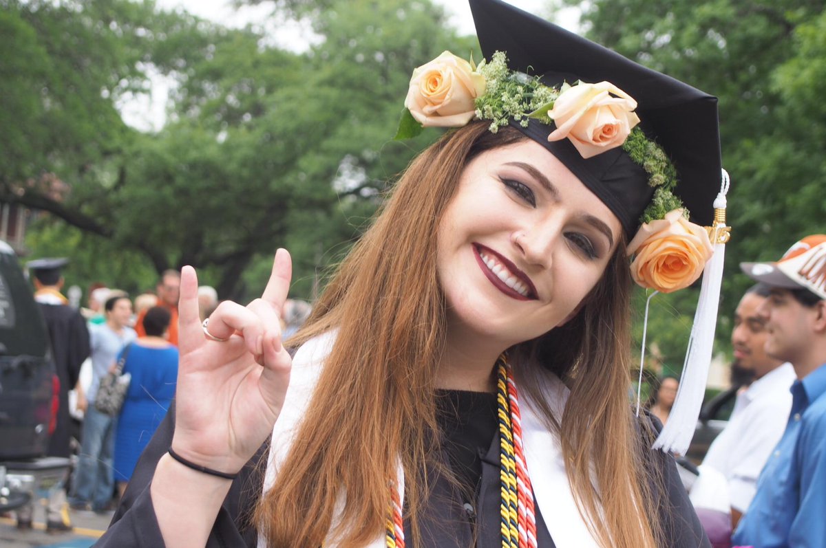 UTAustin's tweet image. Graduates Rachel Di Santo and Gary Scales celebrate after the Dept. of History convocation. #UTgrad #HookEm