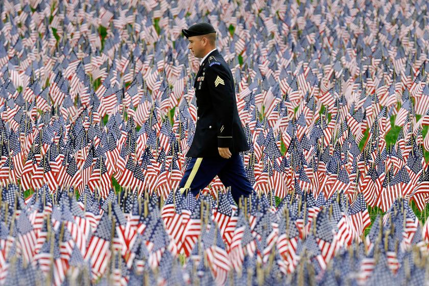 A soldier walks through Massachusetts Military Heroes Fund flag garden in Boston. 
photo:  AP
nypost.com/2015/05/22/the…