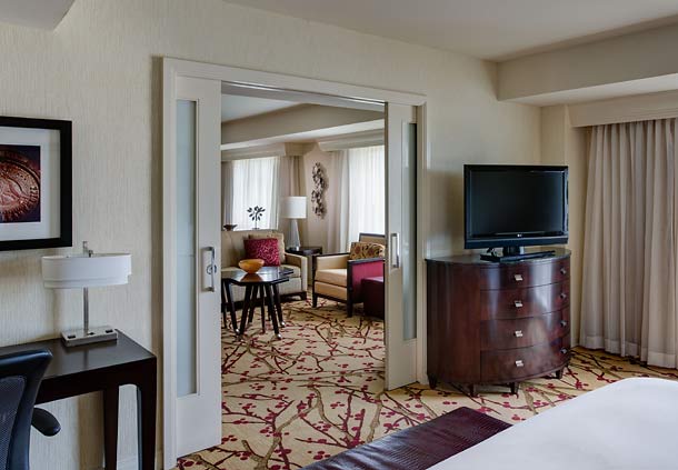 Wake up refreshed after a night of rest in the hospitality suite's king bedroom.