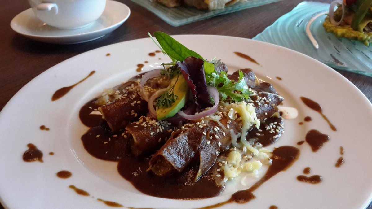 Delicious tortillas, dipped in Mexican chocolate sauce, filled with crumbled panela cheese, Enmoladas! #MexicanFood