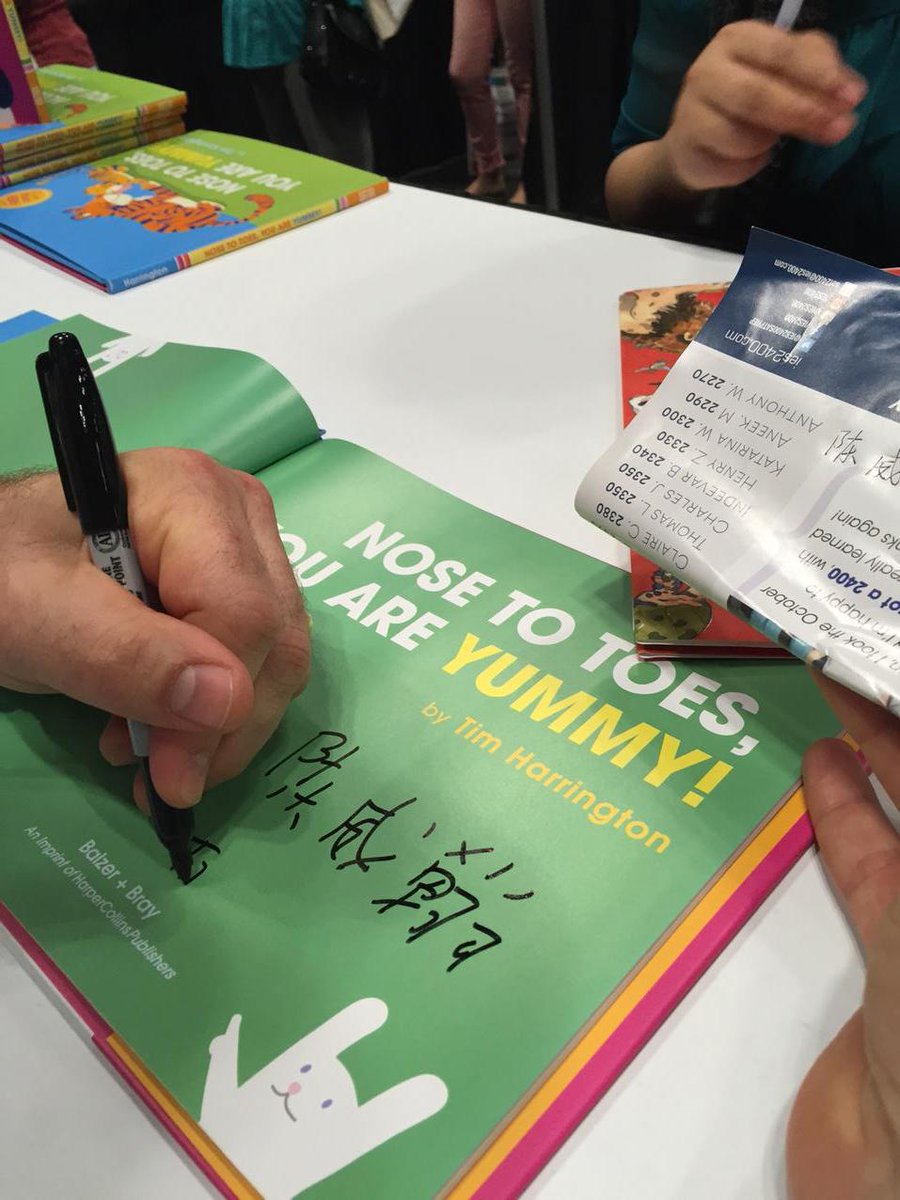 <a href="/yaytim/">Tim Harrington</a> signing Chinese characters with some help at #BEA15!