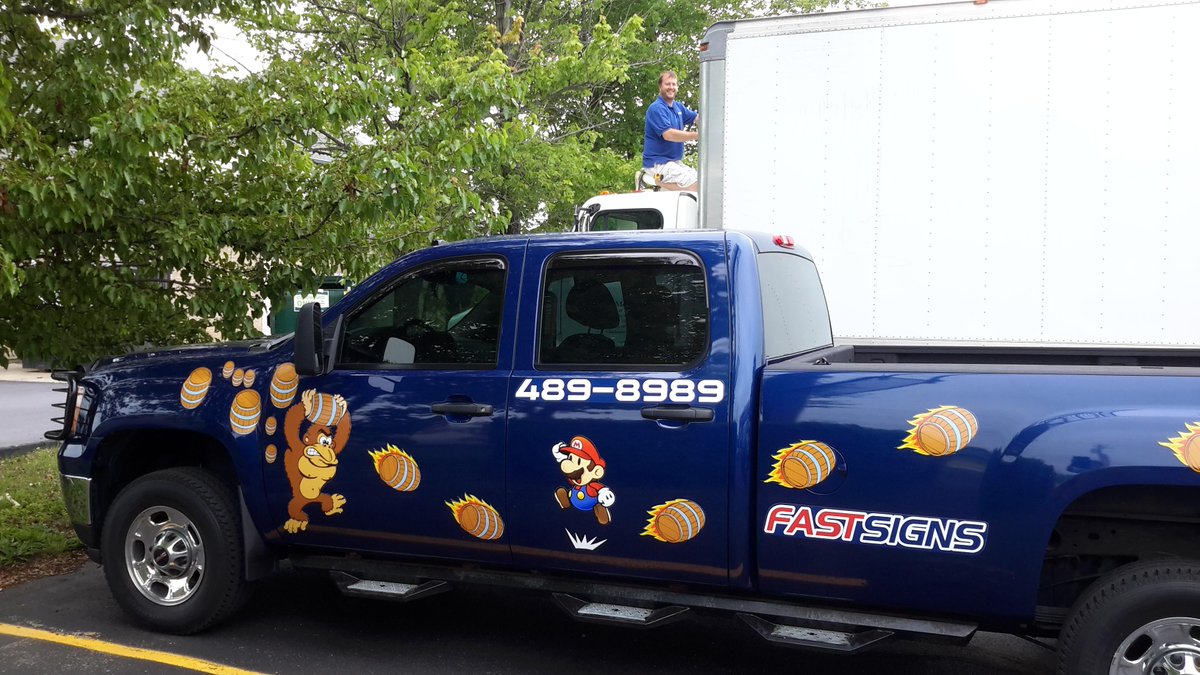 Jon`s truck with it's new retro magnets and him installing vinyl on a moving truck.