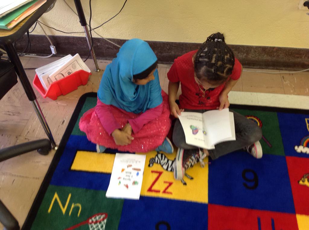 ESL kindergarteners are buddy reading their I See Spring books.