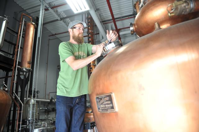 dogfishbeer's tweet photo. A milestone in the development of our new distillery. Graham runs the first wash through the copper. #dogfishspirits http://t.co/hJ94qPB59J