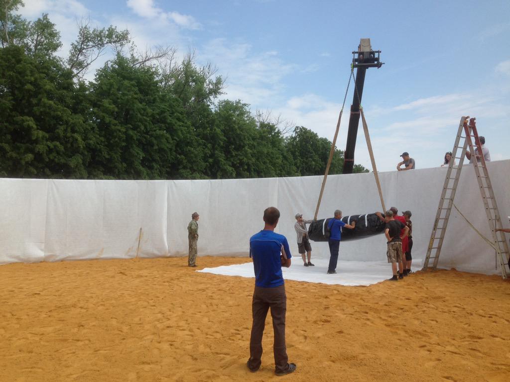 Day 5 in Russia : sand is spread and liner is lifted into position .