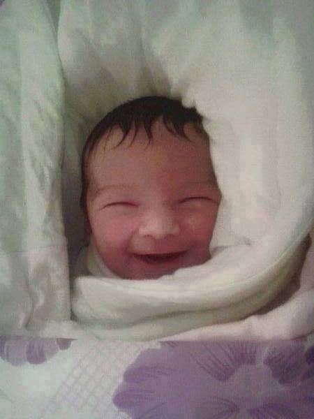 RevolutionSyria's tweet photo. Born smiling in #Yarmouk camp. Sadly, his mother died while giving birth!!! #Syria http://t.co/eHszLMNYWV