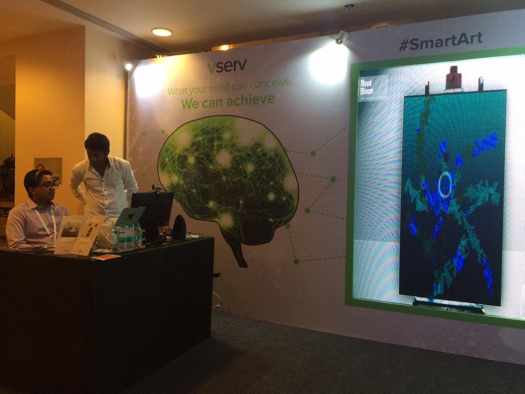 A visitor experiencing the #SmartArt at our booth #11MarCon @IAMAIForum