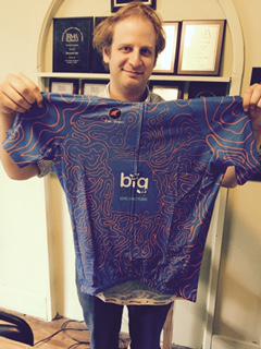 The Jerseys are here. Harry holds one up as proof! He designed them too.