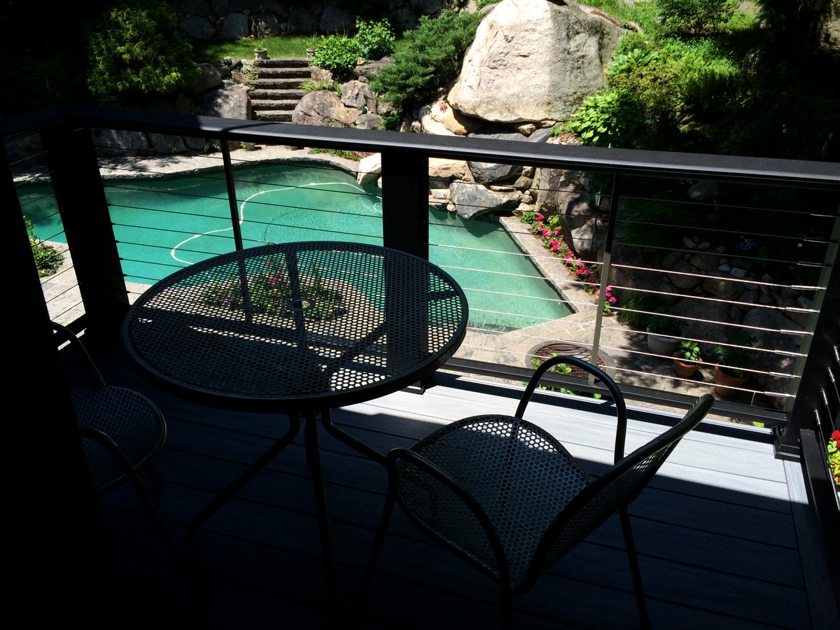 Just completed! A sweet balcony deck with Wolf PVC Decking in Driftwood color &amp; Cable Railing System!
