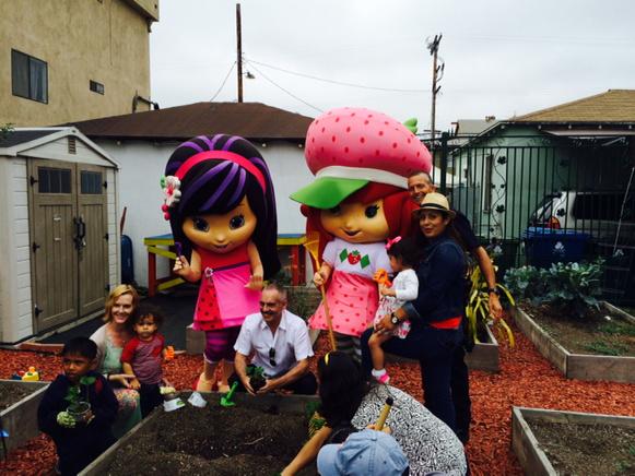 CD 13, the LAPD, Discovery Family Channel, 90210 Cupcakes plant strawberries with kids at Drew St Community Garden.