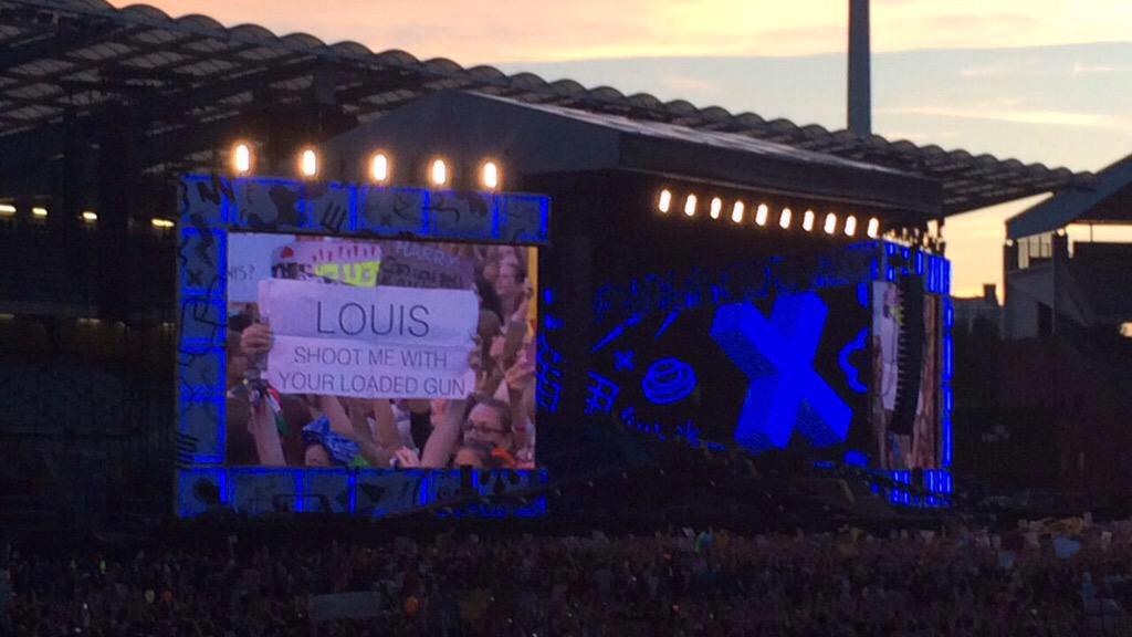Real_Roseanna's tweet photo. My sign from #OTRABrussels on the bog screen behind @Louis_Tomlinson! Also wearingy #BandanaProject bow 🎀 http://t.co/ifGFjkowax