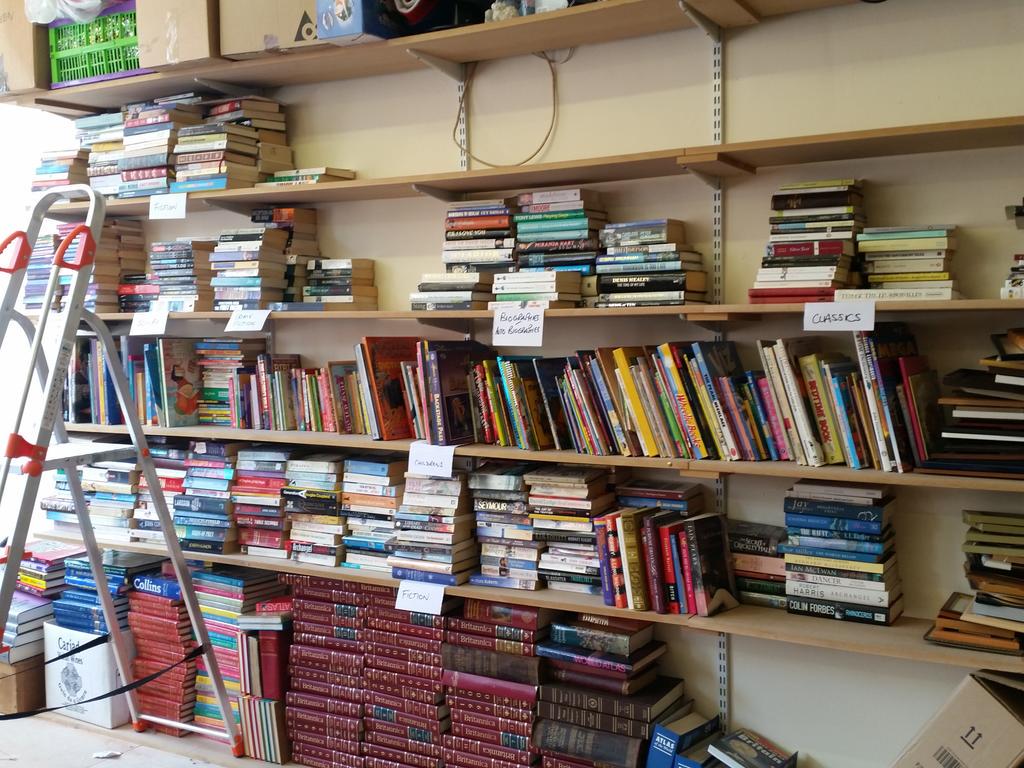 AgeCymru's tweet photo. Fabulous @HughJamesLegal #volunteers creating full shelves of books in genres! #likealibrary http://t.co/9EucGUVEiB