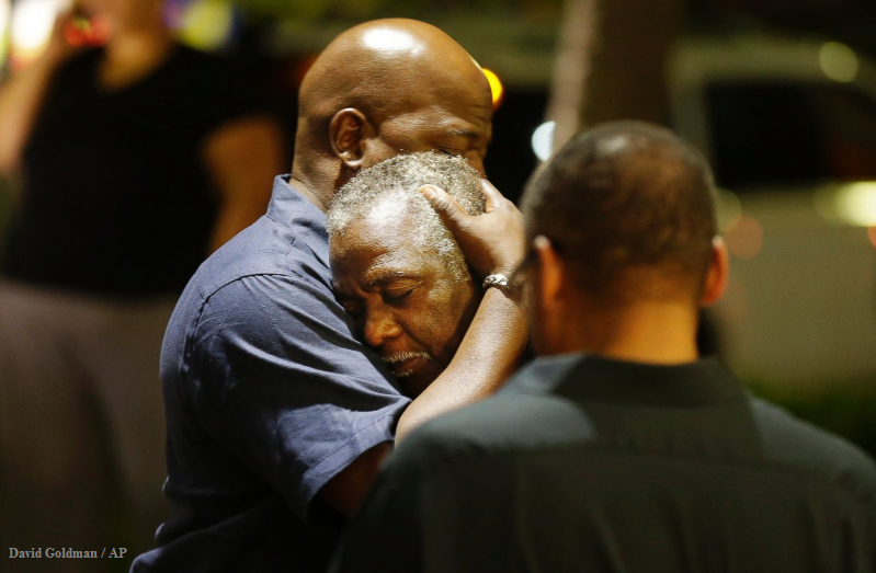 GMA's tweet image. Worshipers embrace following group prayer near scene of the mass shooting at Emanuel AME Church in #Charleston, SC