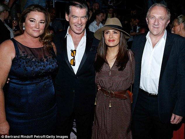 Pierce Brosnan and Salma Hayek at the Yves Saint Laurent fashion show in Paris ow.ly/OVdlr