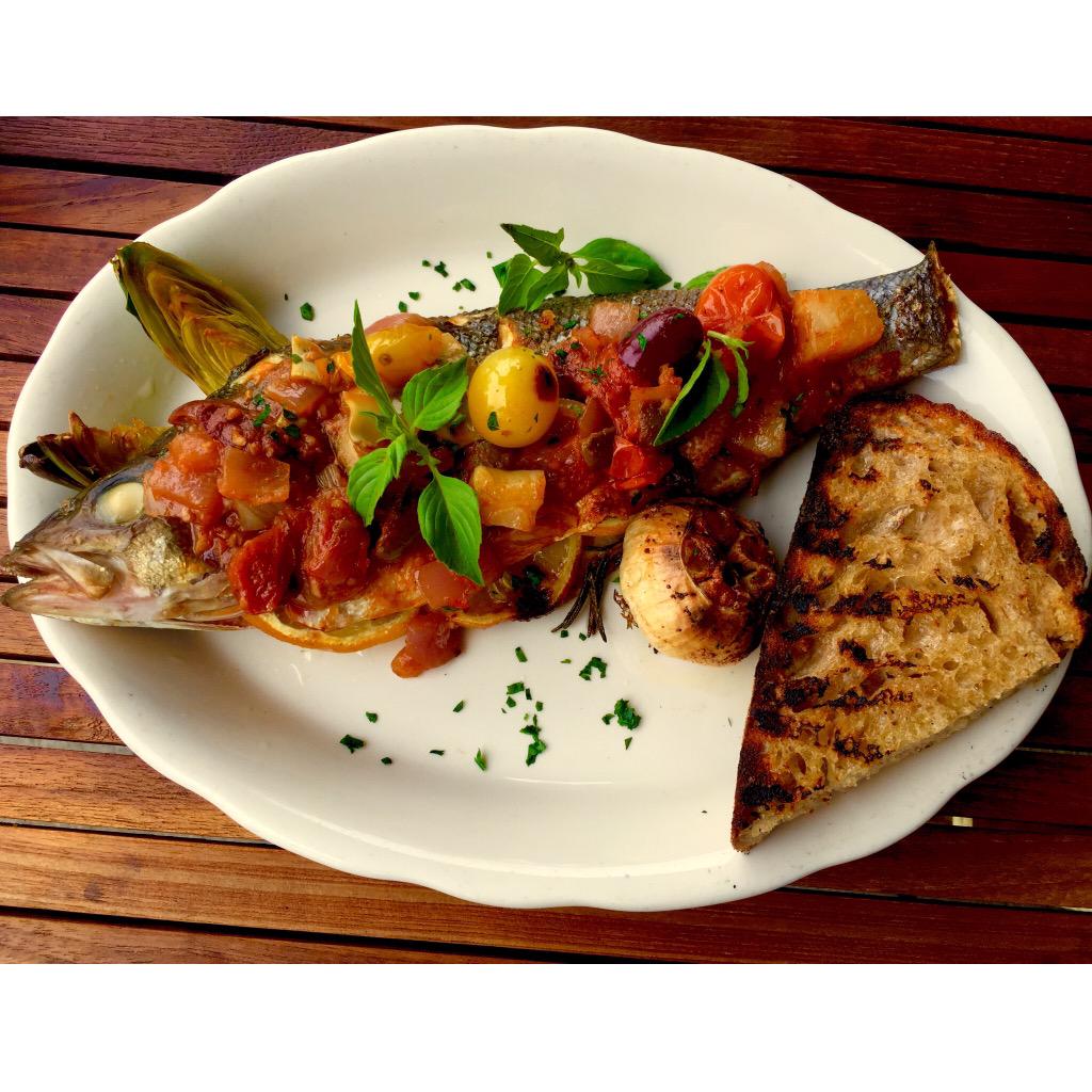 LEOysterBar's tweet photo. Bronzino, braised heirloom tomato, anchovy, olives, lemon basil, artichoke, the amazing @kandvbake sourdough tho. http://t.co/GsrROip0U6
