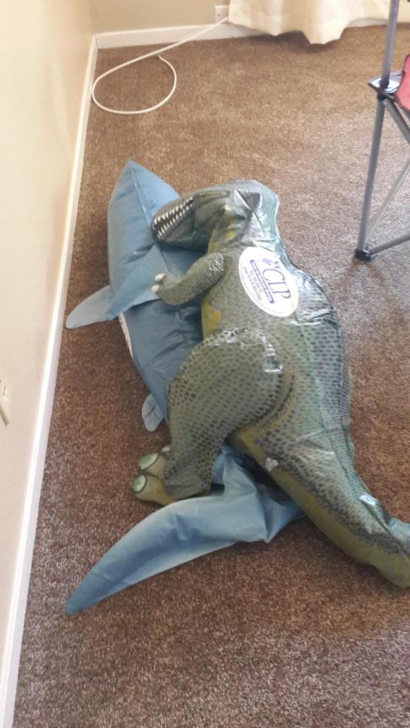Shark and T-Rex caught in a compromising position.