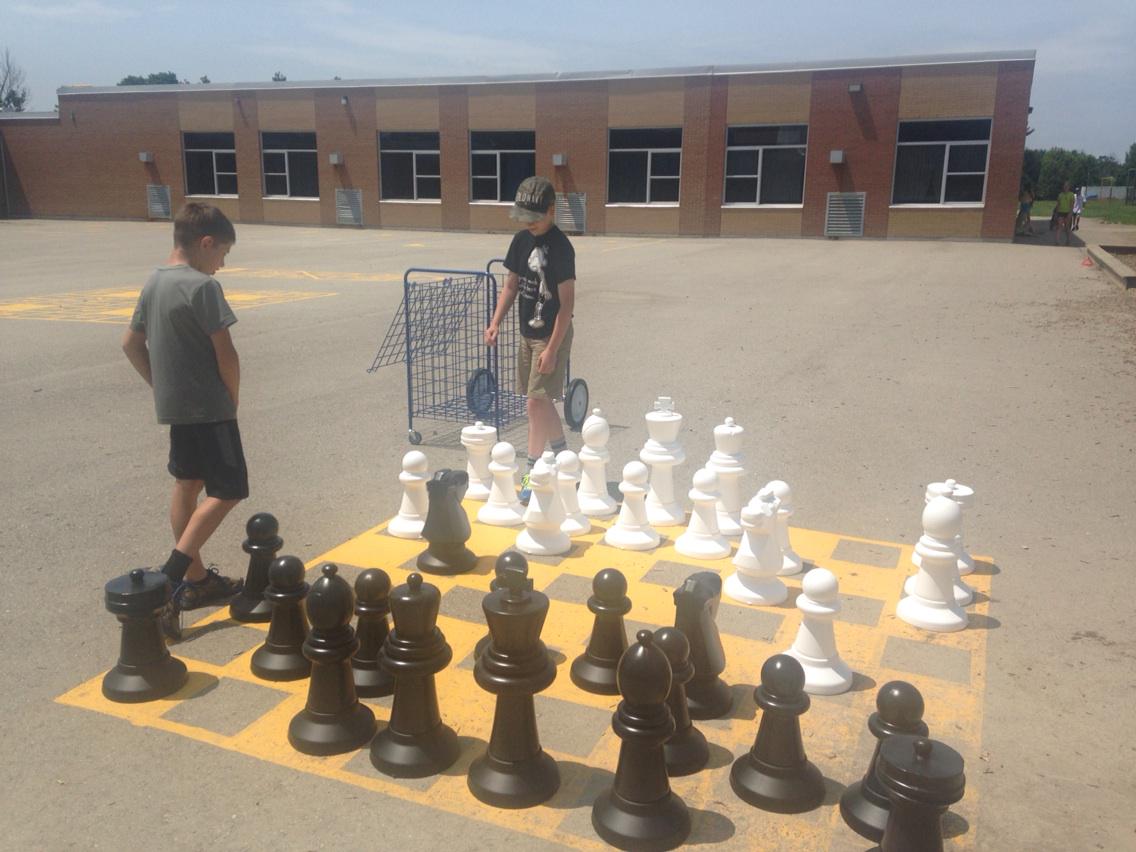 Playing chess on the last day of school. We love our giant chess set!