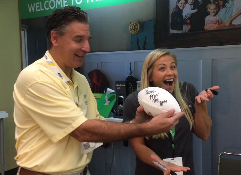 QolsysInc's tweet photo. #AskJenni star @JenniNewman89 autographs one of the @VectorSecurity footballs at #ESX2015 http://t.co/e0G0yGIeaM