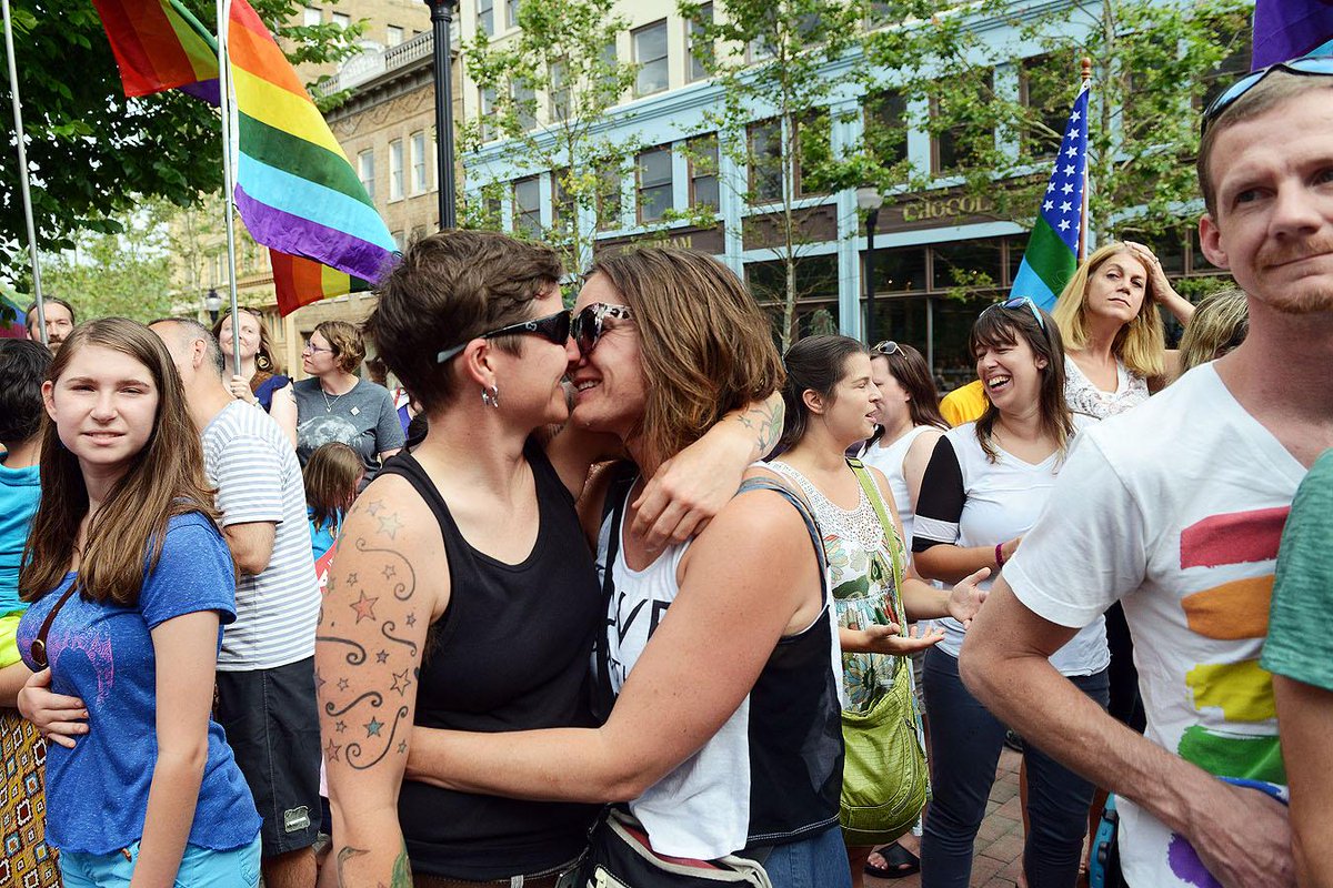 wwoodyCO's tweet image. #Asheville residents Kathleen McCafferty and Robyn Moser embrace during same-sex marriage rally downtown. #avlnews
