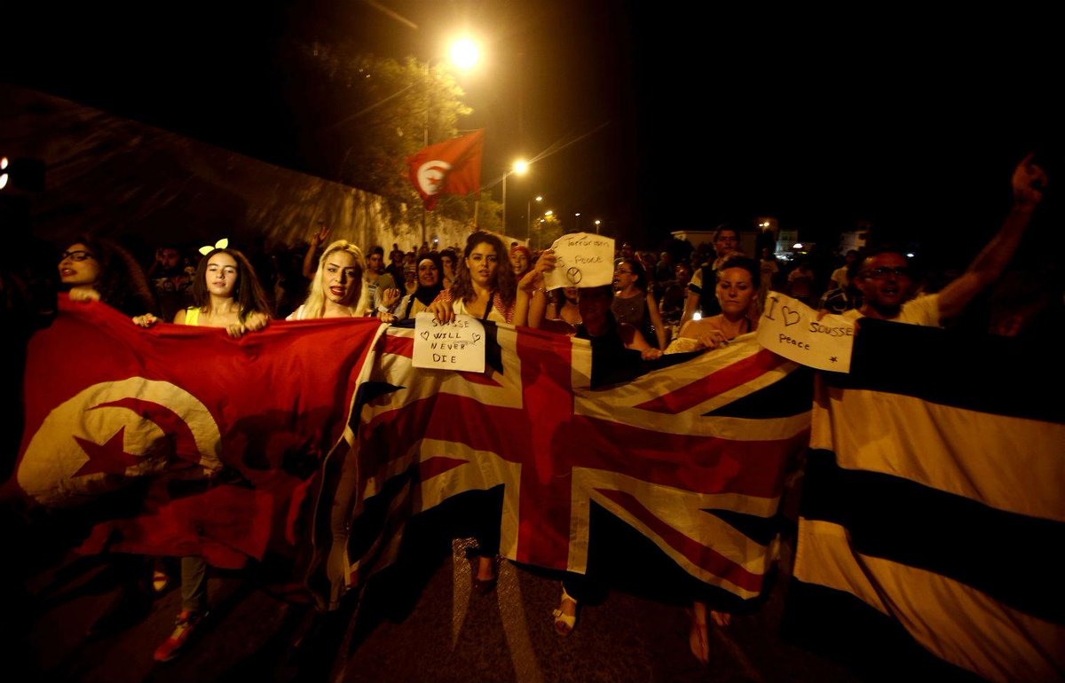 Independent's tweet photo. Tunisians with British flags march against terror in candlelight protest http://t.co/7mnHg0x86f http://t.co/qLgmRhojv3