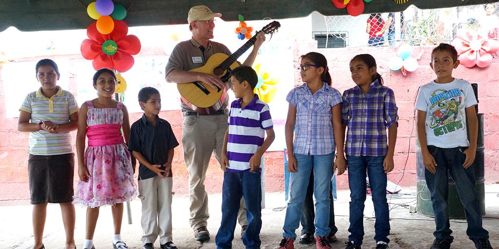 UnboundOrg's tweet photo. President and CEO @Scott_Unbound making musical memories with sponsored children in El Salvador. #MusicMonday http://t.co/mvpKkELa0w