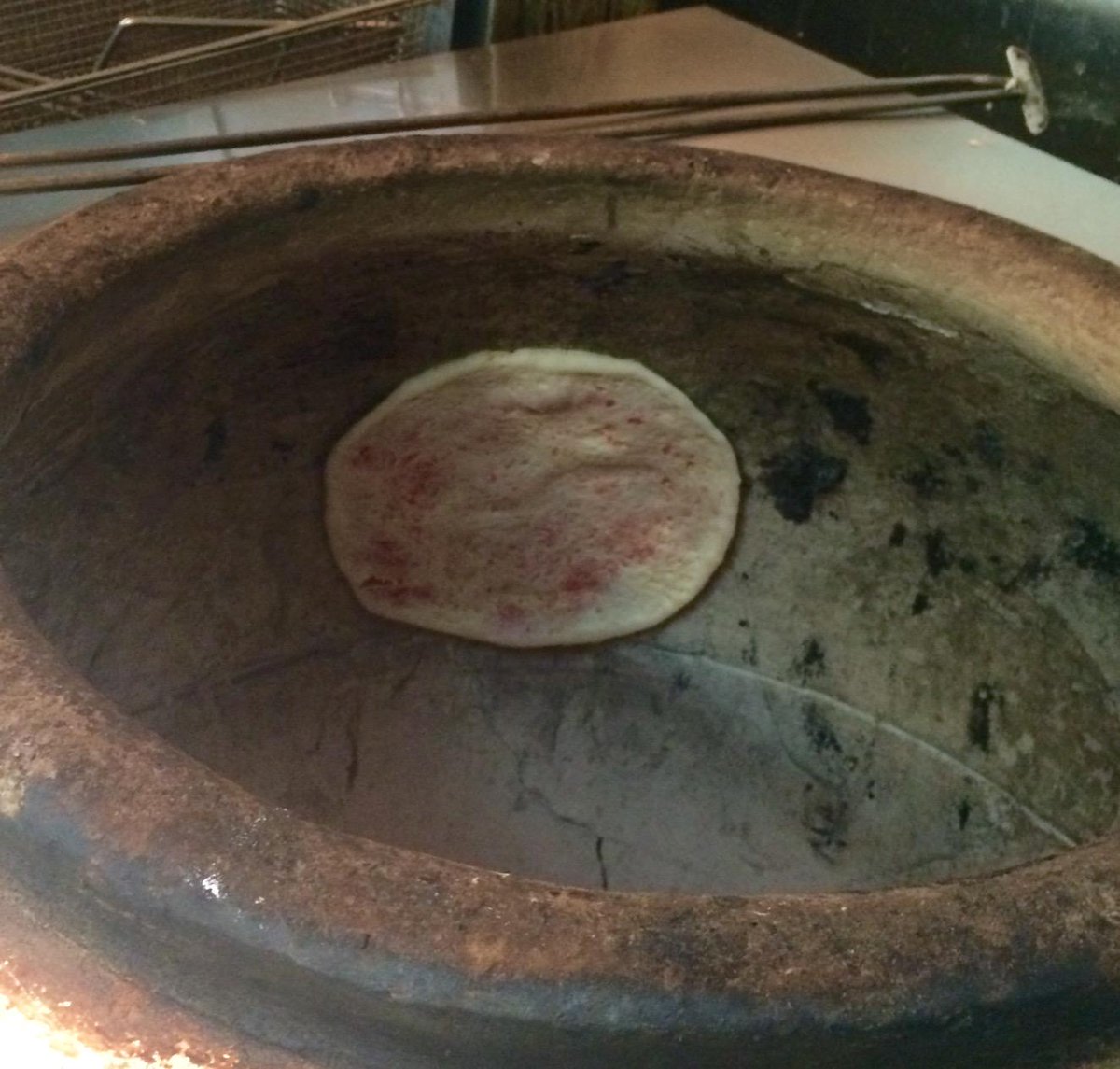 Here's the naan baking in the tandoor--kind of amazing how it sticks! #YYJ <a href="/s_tandoor/">Sizzling Tandoor</a>
