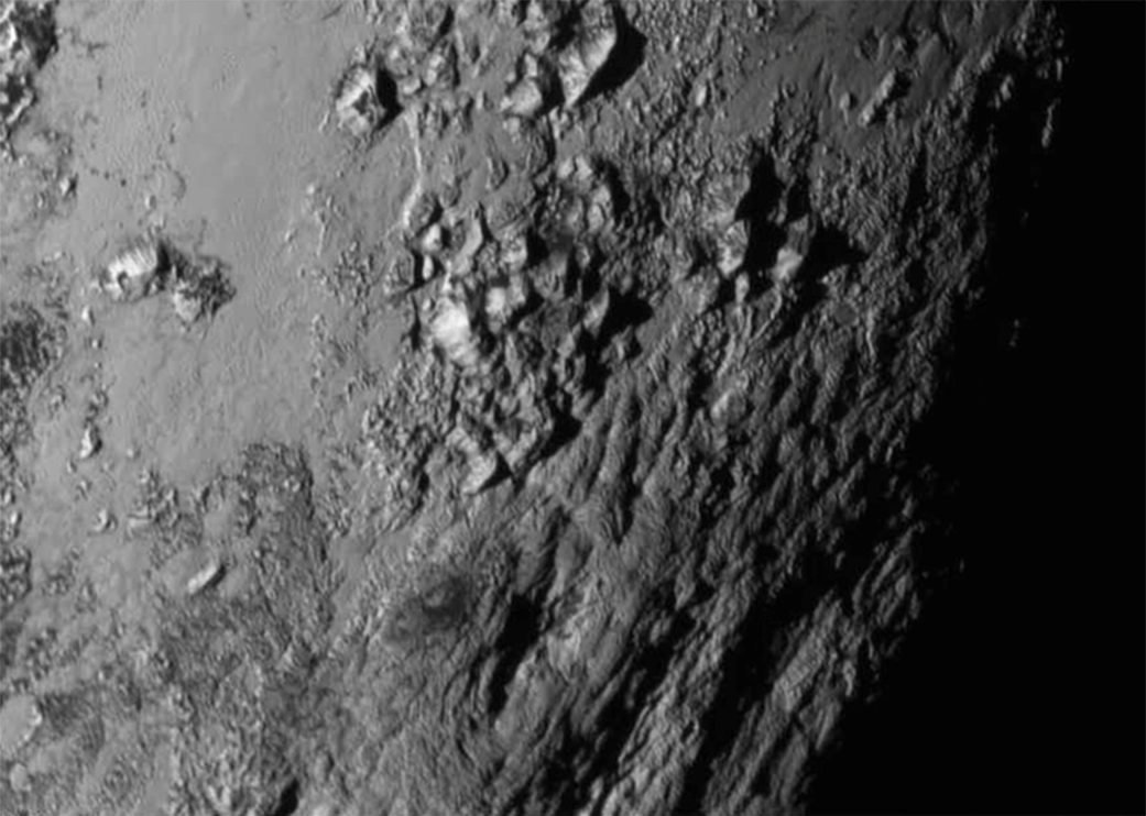 Huge surprise from #PlutoFlyby - Mountains rising 11,000 ft above the dwarf planet! 1.usa.gov/1V4fsaN