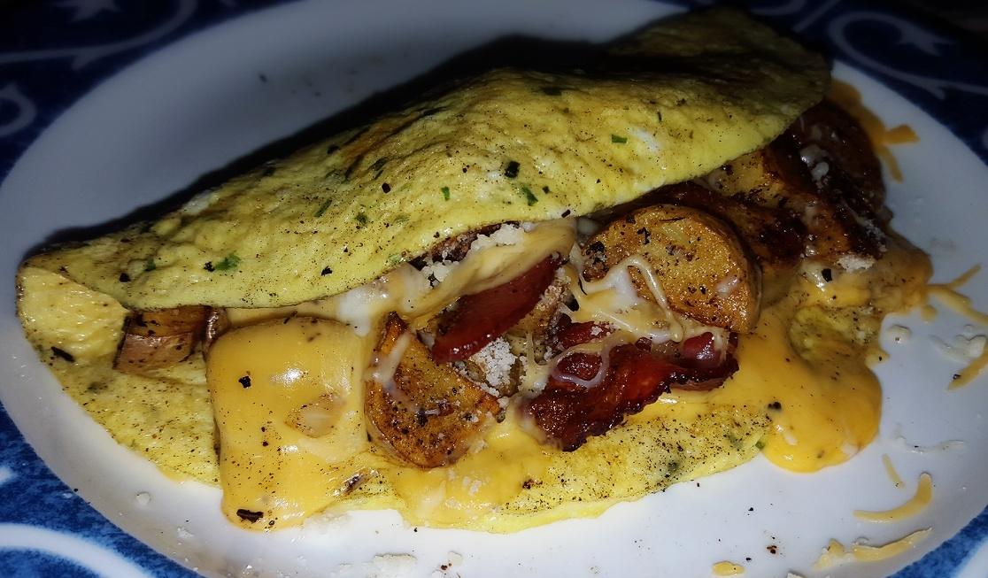 Breakfast taco omelette. #reducedfat cheese/bacon/homefries/onions
