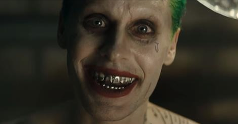 RollingStone's tweet photo. Watch the eerie new #SuicideSquad trailer, featuring Jared Leto' grotesque take on the Joker: http://t.co/rabtw2iRP1 http://t.co/AUGj7gQpuj