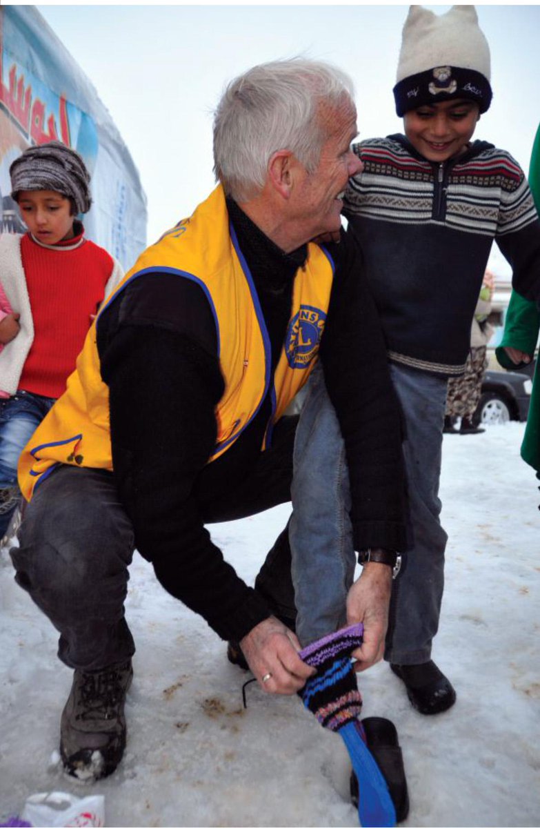 isaame2015's tweet photo. Einar Lyngar puts socks on a boy. (Opposite) Children in the refugee camps lack warm
clothes for the frigid weather. http://t.co/NiHCjmKQTj
