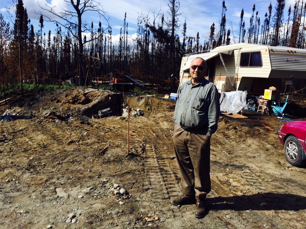 laciegrosvold's tweet image. Bruce stands in front of his new home the trailer and the pit where his house used to be. #CardStreetFire #KTUU