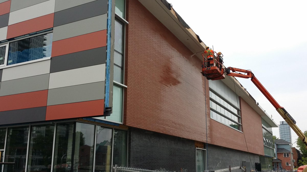 CSPArch's tweet image. Power washing the brick veneer at Regent Park Community Centre.  It’s getting there! #anticipation #designwithcolour