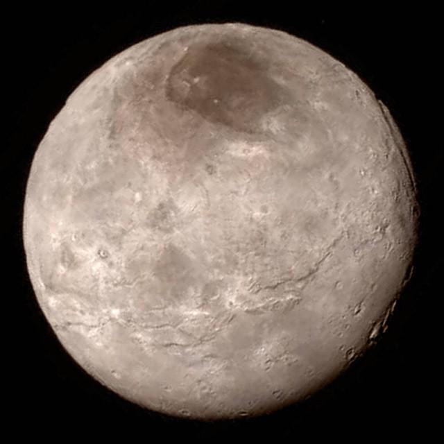 ObamaWhiteHouse's tweet photo. One does not simply fly 3 billion miles to take a photo of Mordor, the dark spot on top of Pluto's moon Charon. http://t.co/uzwfEtzGgM