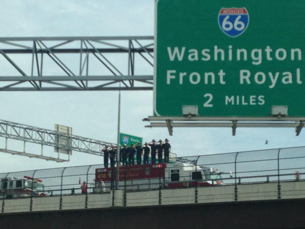 JulieNiemela's tweet photo. Firemen salute during police escort for #CarlosSilva #Brazil investigator killed in #WPFG bicycle accident. http://t.co/vyxM4kPBF7