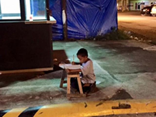 etribune's tweet image. Homeless boy uses McDonald’s light to do homework tribune.com.pk/story/917751/h…