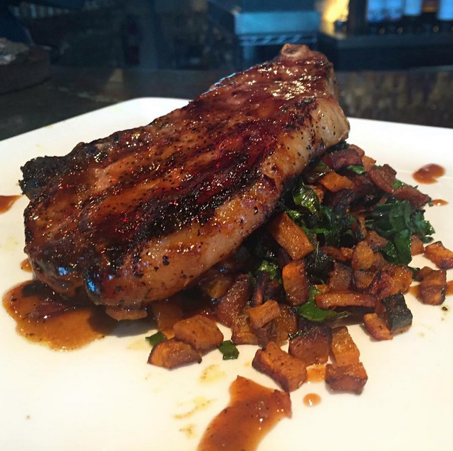 8 oz. grilled pork chop served with sweet potato hash, sautéed kale &amp; chipotle BBQ sauce